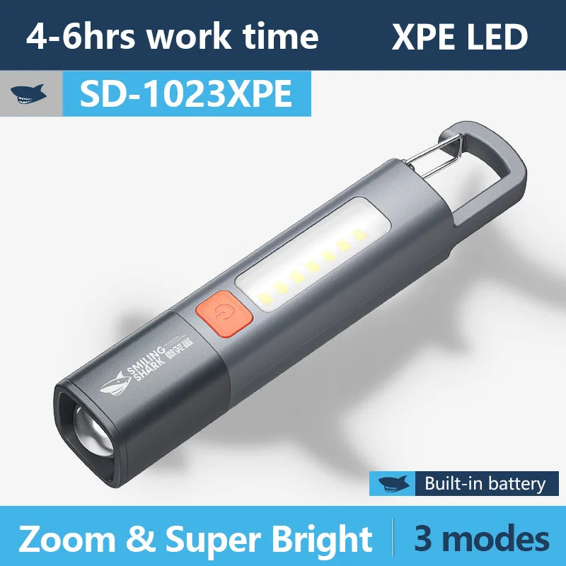 1pc Smiling Shark SD1023 LED Torch Light XPE Super Bright Flashlight with Hook Camping Light Rechargeable Zoomable Waterproof